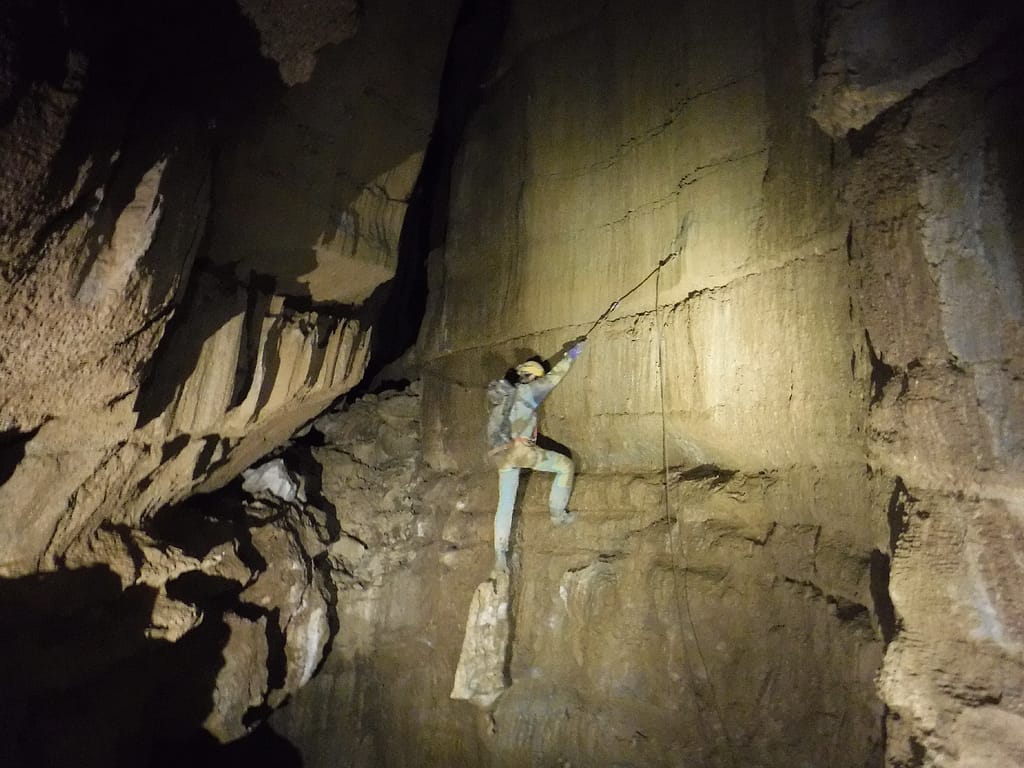 A caver is traversing over a 70 m (210 feet) deep shaft. Photo: Phillip Moneyhun