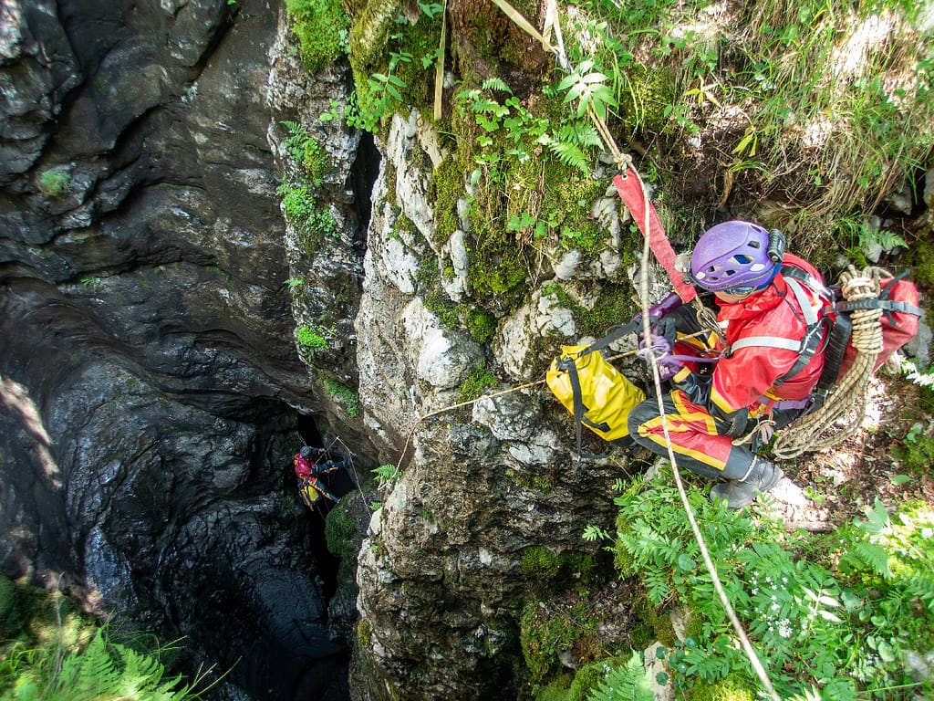 Cavers are entering Vručični Snovi Cave and waiting for their turn to descend into the cave. Montenegro 2023. Photo: Katarina Kosič Ficco