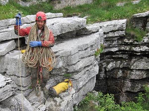 A caver coiling the rope after finishing with cave exploration. Photo: Vid Naglič