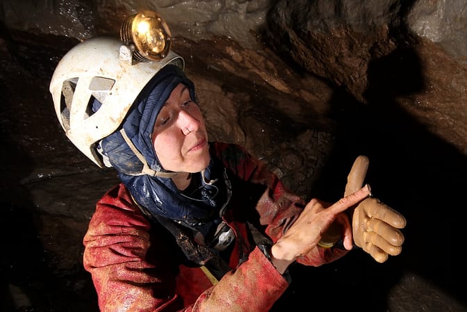 A posing cave millipede with its hunter, Špela Borko. Vručični Snovi Cave, Montenegro, 2023. Photo: Jeff Wade