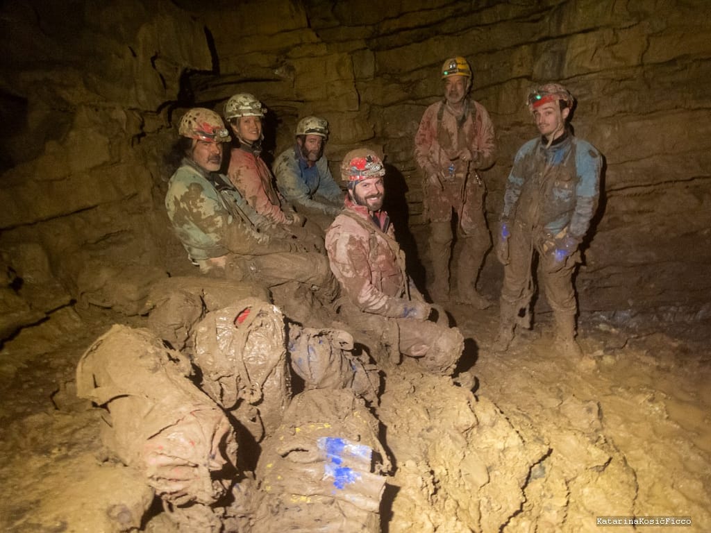 Resting and waiting are two crucial parts of caving. Here, cavers are taking a breather while waiting for the gear to be pulled up by a shaft.